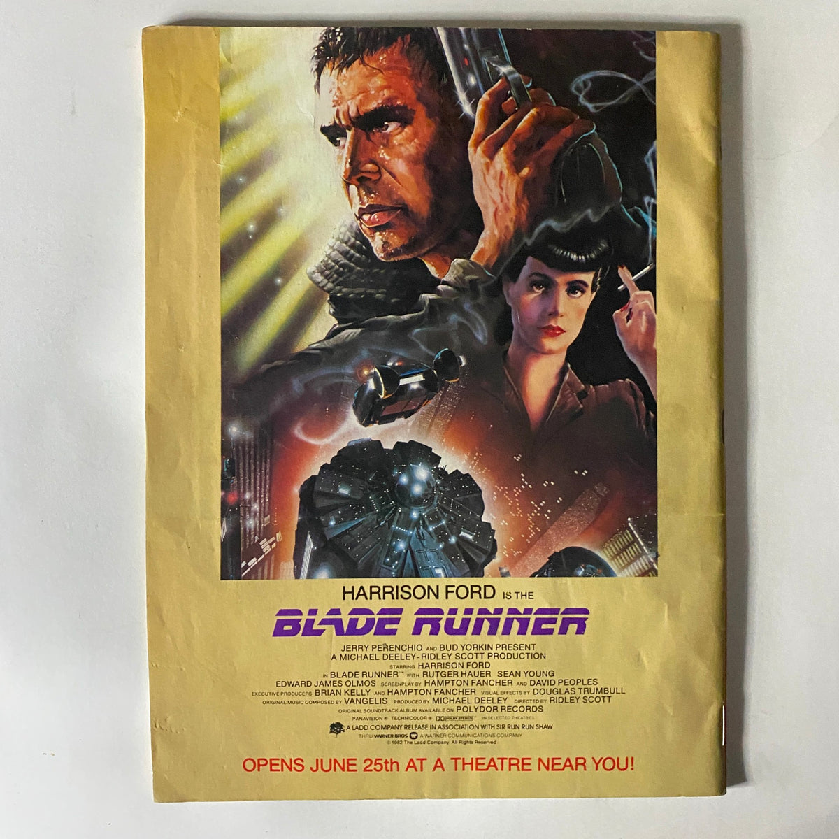 Prevue Magazine July 1982 includes an advertisement for the movie Blade Runner, starring Harrison Ford. The image captures the iconic artwork and promotional design that represents the classic sci-fi film's aesthetic from the era.