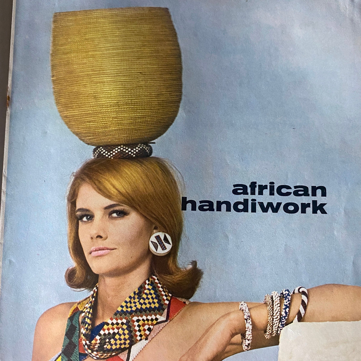 Caper Magazine March 1964, Volume 10, No. 2 page titled 'African Handiwork' depicting a model with a decorative hairstyle and colorful attire, illustrating the magazine's artistic focus on cultural themes.