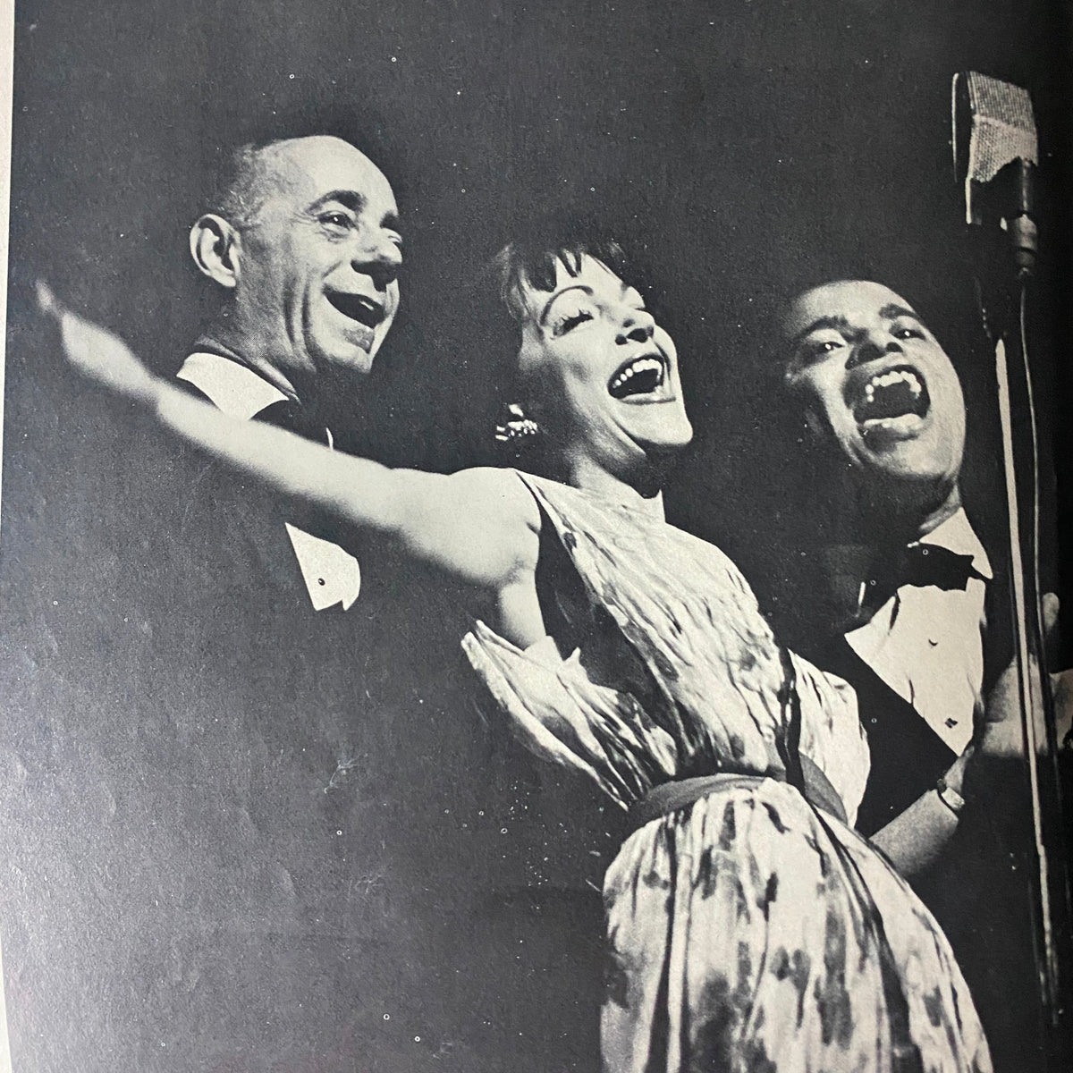An engaging performance scene from Mr. Magazine March 1964 Vol 8 No. 4, depicting three singers joyfully engaging with the audience, showcasing the vibrant culture of the 1960s.