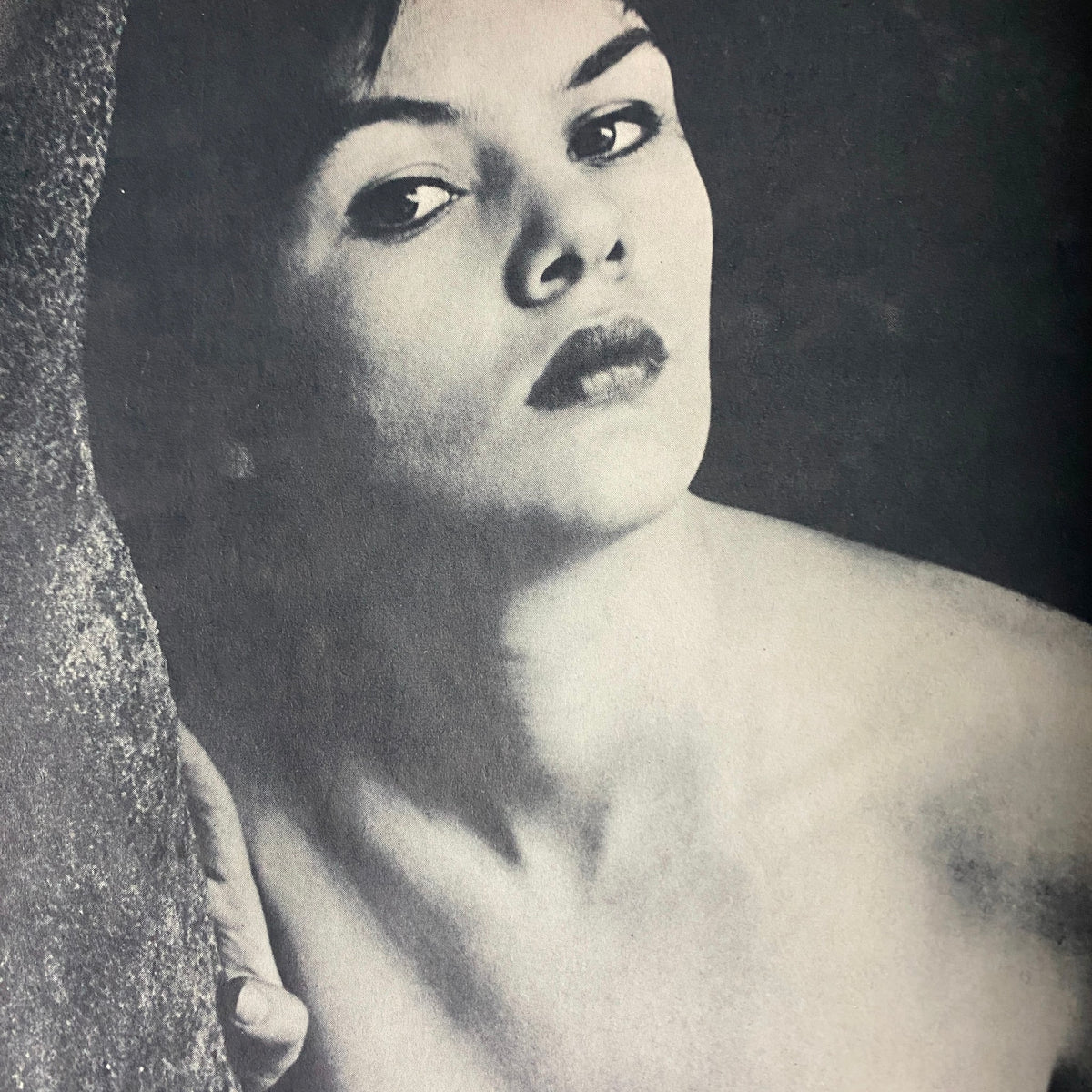 Artistic black and white photograph of a model featured in Scamp Magazine March 1961.