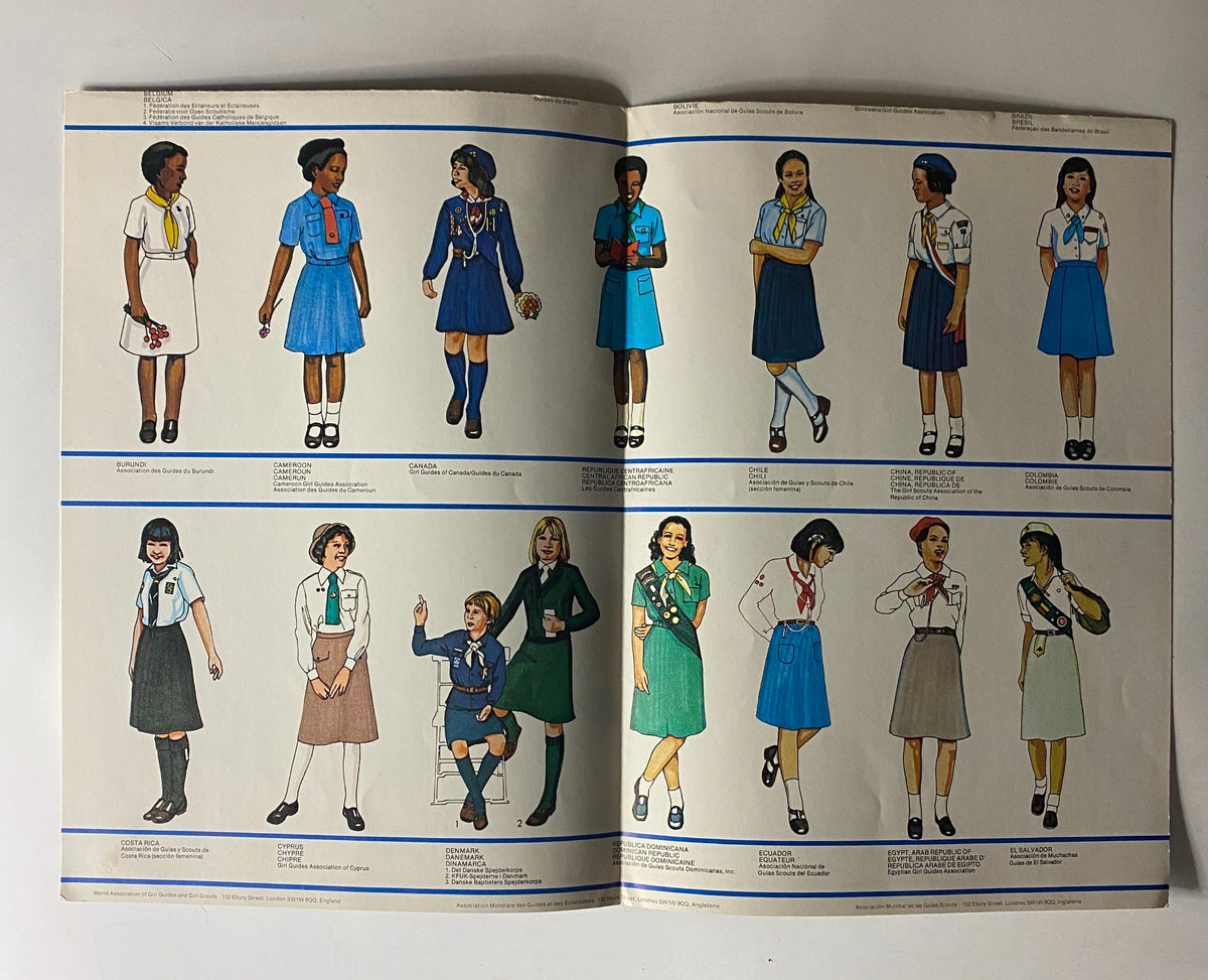 Page from the 1980 Uniform of the Girl Scout and Brownie Scout Equipment Catalog #1 displaying illustrations of Girl Scout uniforms from multiple nations, highlighting diverse styles and designs.