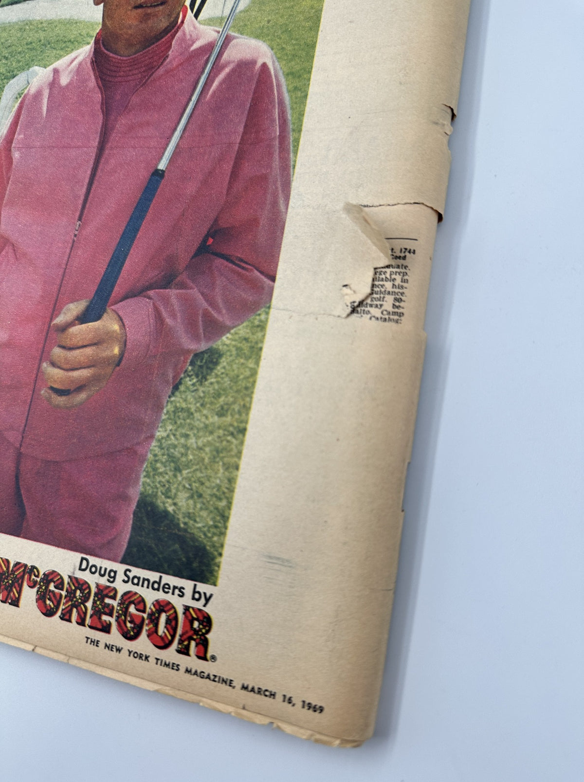 The New York Times Magazine March 16, 1969 cover featuring golfer Doug Sanders in a pink outfit, showcasing significant wear including a tear. The image captures the magazine's worn condition and its historical value.