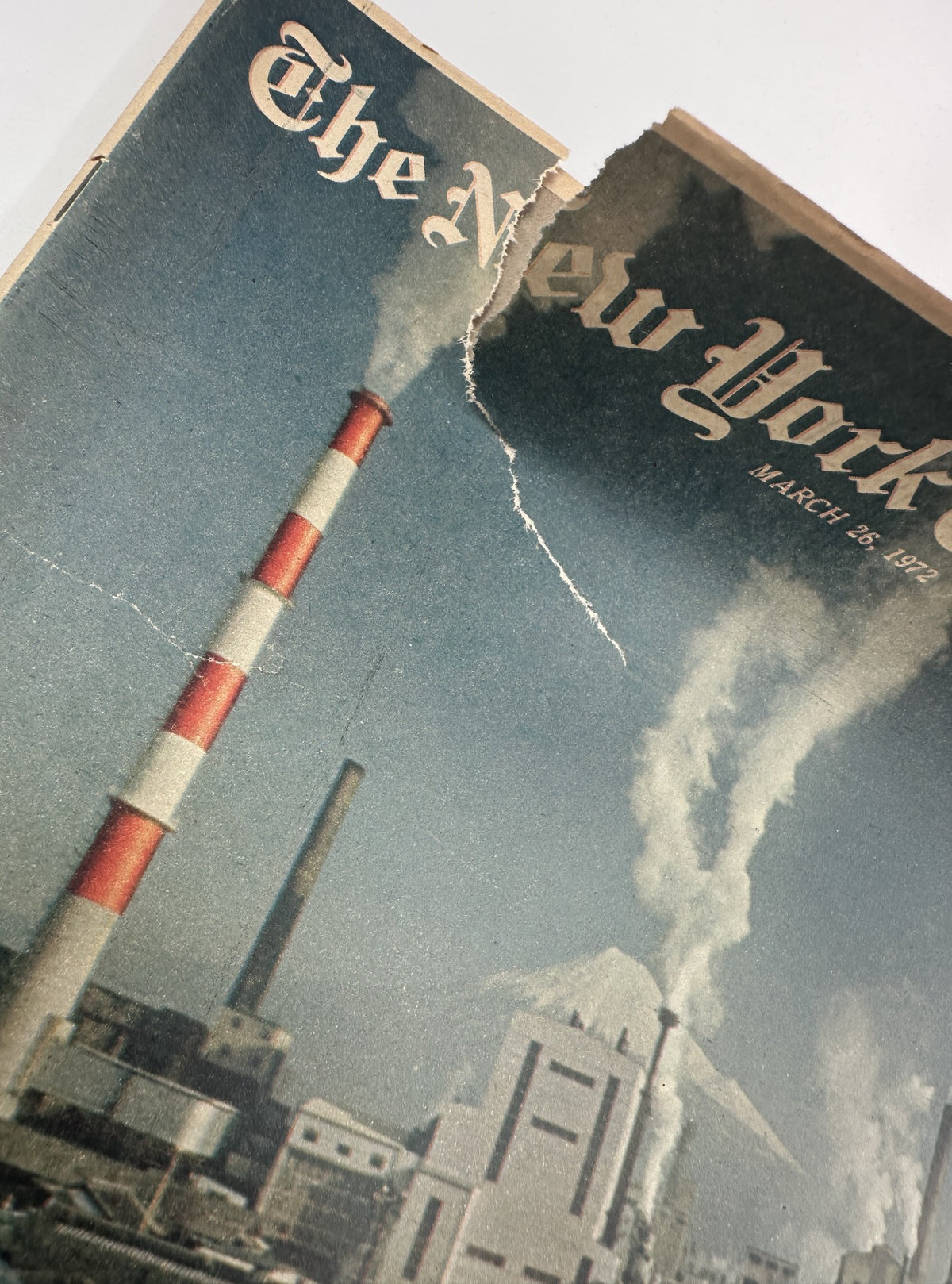 Close-up view of the cover of The New York Times Magazine March 26, 1972, showing damage with a tear and smoke from industrial pollution.