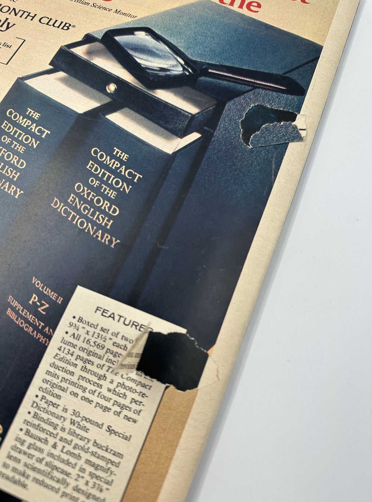 Close-up of a damaged corner of The New York Times Magazine December 12, 1976, showcasing wear and tear on the cover. The magazine includes discussions on language and features contributors like Ben Katchor.