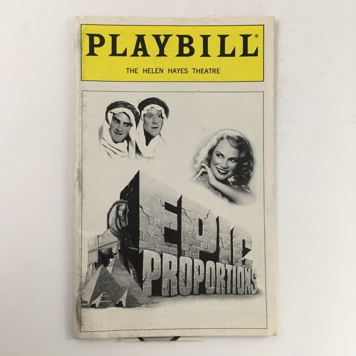 Cover of the 1999 Playbill for 'Epic Proportions' featuring the title prominently with images of actors and the backdrop of pyramids.