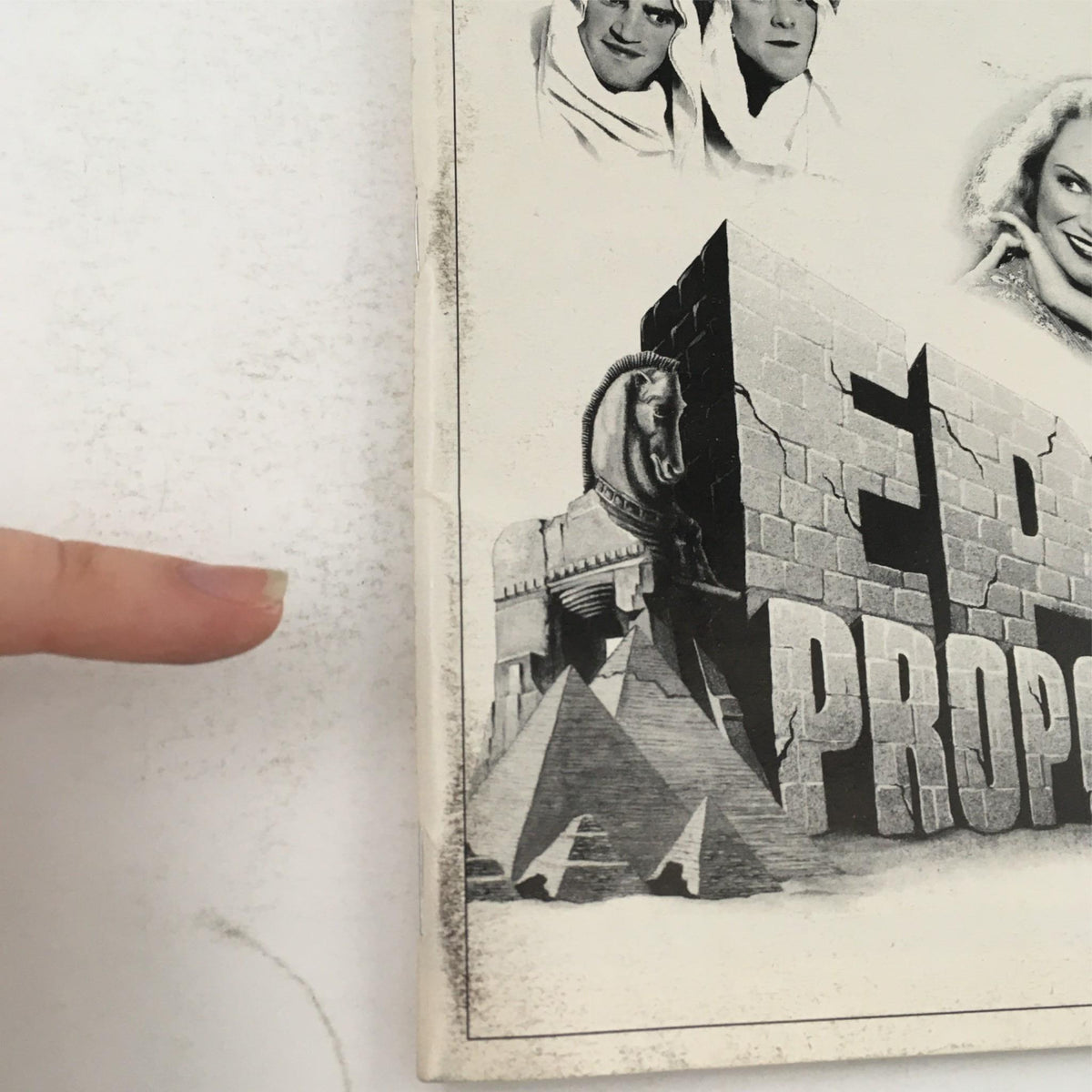 Close-up of the cover art for the 1999 'Epic Proportions' Playbill, highlighting the title and visual elements of pyramids and characters.