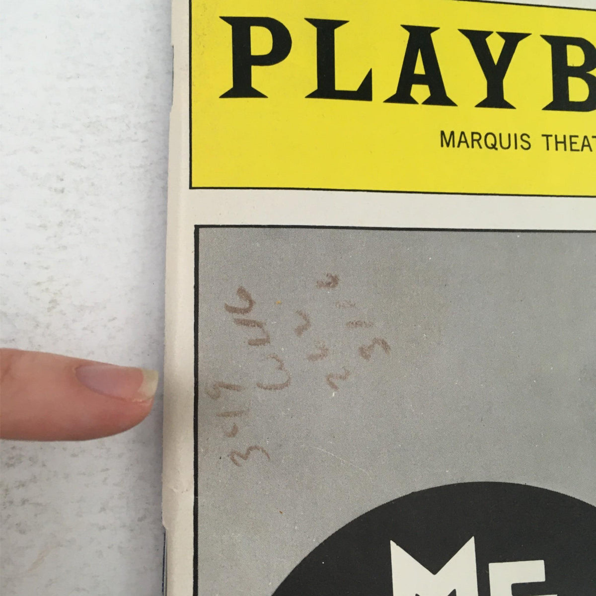 Close-up detail of the spine of the 1989 Playbill for 'Me and My Girl,' showing some handwritten notes and markings indicative of its vintage status.