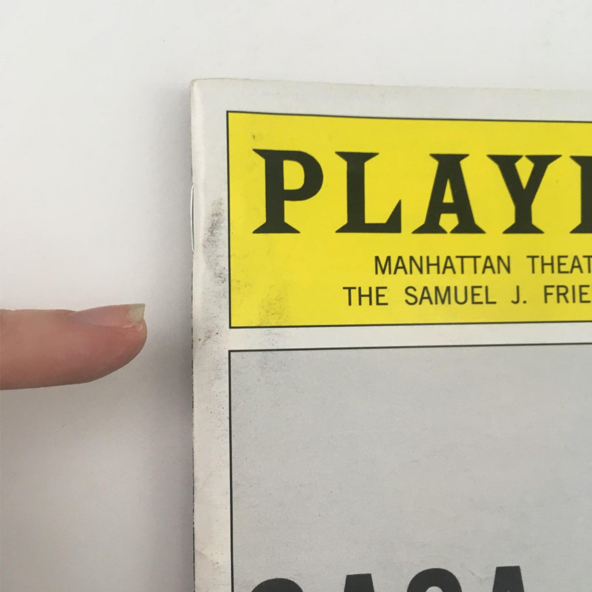 Close-up of the 2014 Playbill for Casa Valentina by Harvey Fierstein, showcasing minor wear on the cover and the iconic yellow title at the top.