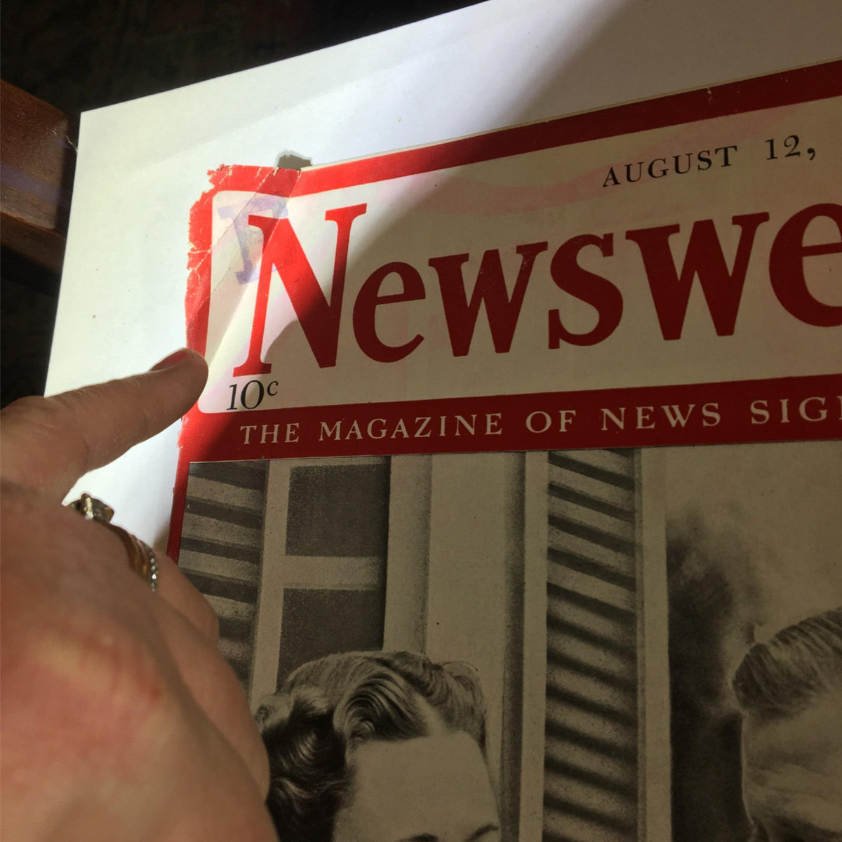 Close-up of the top corner of the Newsweek Magazine August 12, 1940, showing details of the magazine's title and cover wear.