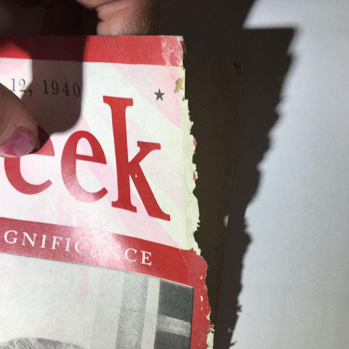 Close-up of the side of the Newsweek Magazine August 12, 1940 showing frayed edges and worn cover.