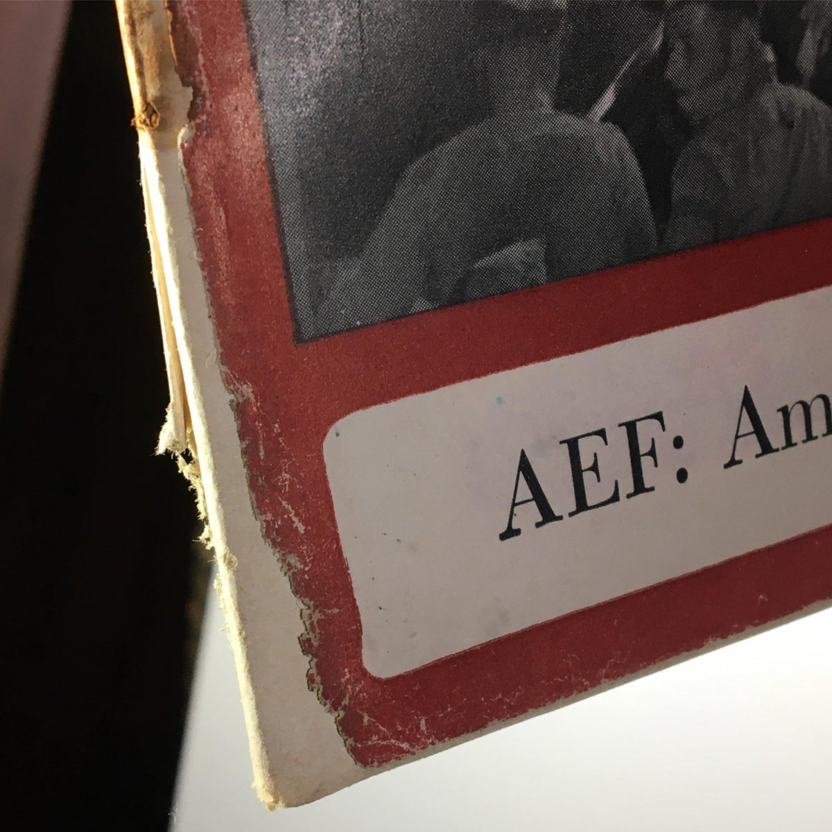 Detail of the spine of the Newsweek Magazine February 2, 1942, showing the subtitle: AEF: America's Man Power Moves Overseas, with signs of aging and damage.