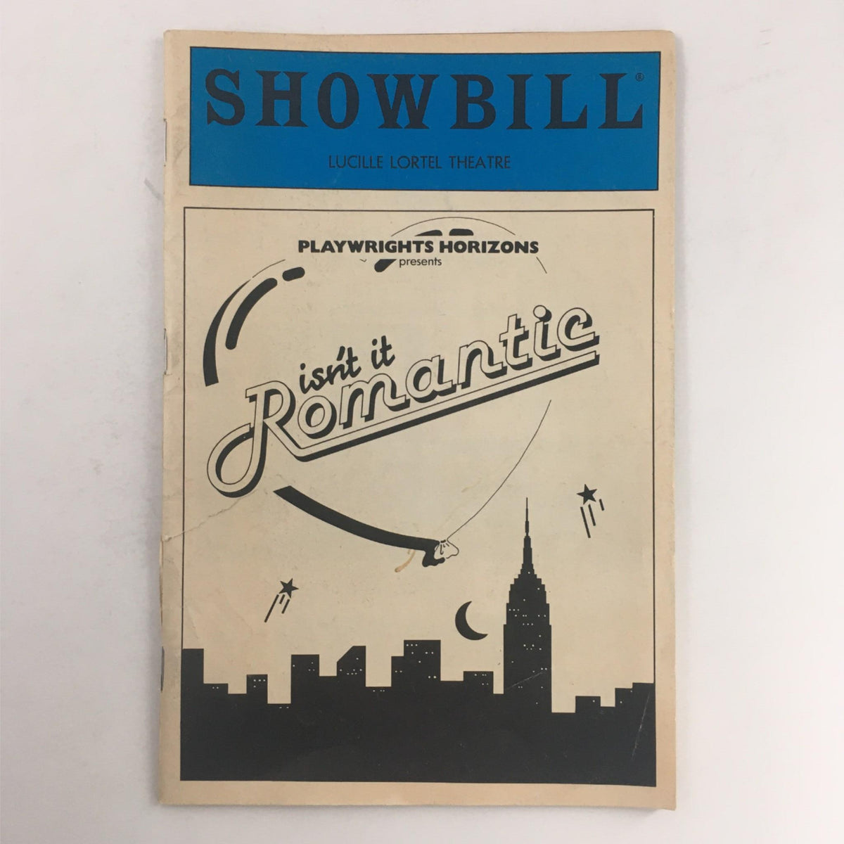 1984 Playbill for Isn't It Romantic by Wendy Wasserstein, featuring striking design and the Lucille Lortel Theatre logo.