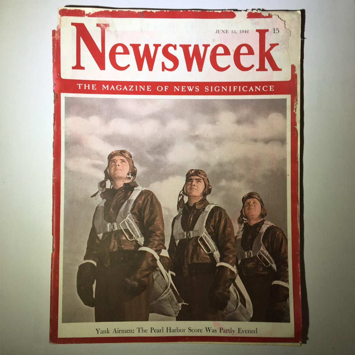 Cover of Newsweek Magazine June 15, 1942 featuring Yank airmen, with headline stating 'The Pearl Harbor Score Was Partly Evened.' The image showcases three airmen in flight gear gazing upwards against a cloudy sky.