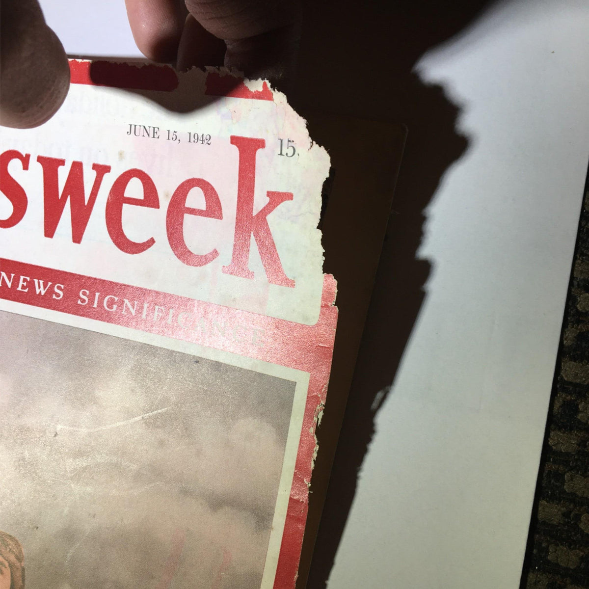 Close-up of the top portion of Newsweek Magazine June 15, 1942, highlighting the torn edge and the title, emphasizing the magazine's historical significance in discussing the Pearl Harbor events.