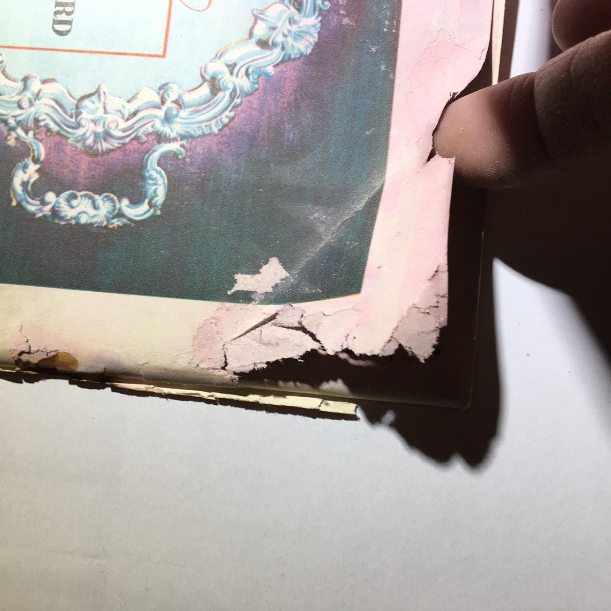 Detailed view of the damaged back cover of the June 15, 1942 Newsweek Magazine, highlighting the advertisement for Old Taylor whiskey.