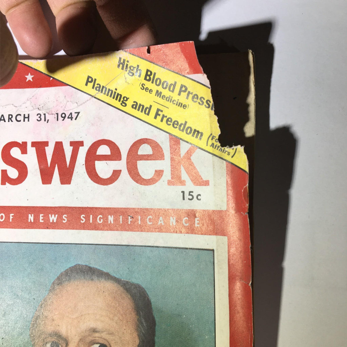 Close-up of the Newsweek Magazine cover dated March 31, 1947, prominently displaying the title 'Fifteen Years a Fall Guy' and a tear on the top corner.