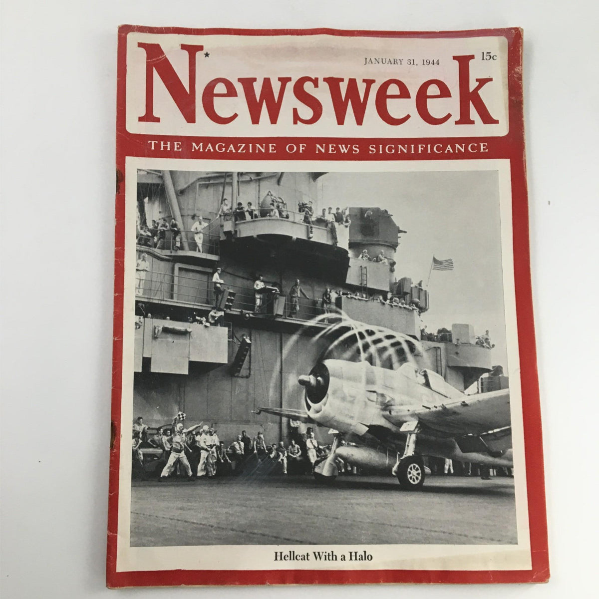 Cover of Newsweek Magazine from January 31, 1944 titled 'Hellcat With A Halo', featuring a historic image of a fighter plane and personnel on an aircraft carrier.
