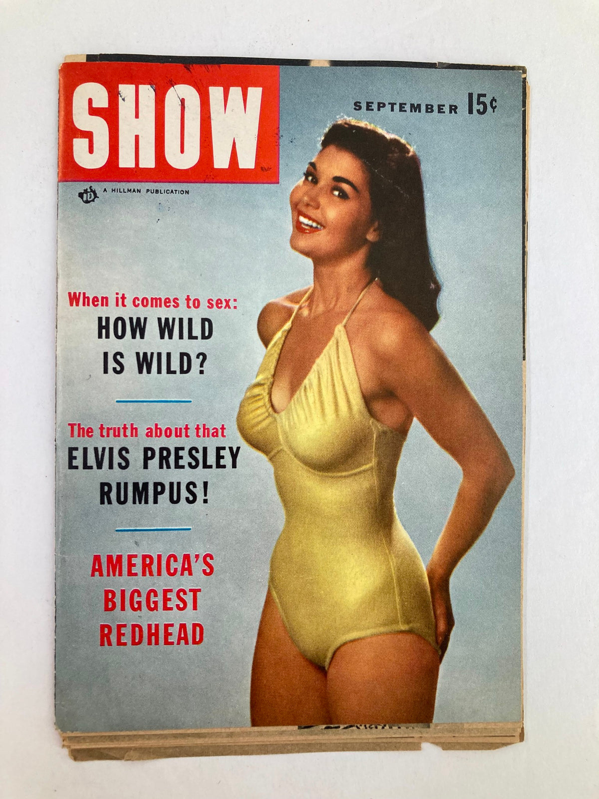Cover of Show Magazine from September 1955 featuring a model in a yellow swimsuit and the headline 'When it comes to sex: HOW WILD IS WILD?'. The magazine prominently showcases 'The truth about that ELVIS PRESLEY RUMPUS!' and is marked as America's Biggest Redhead.