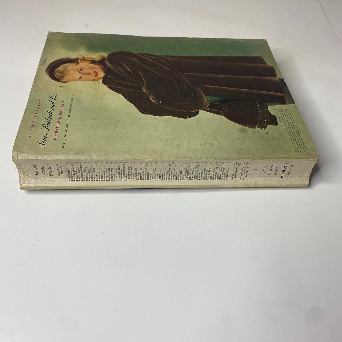 Side view of the 1946 - 1947 Sears, Roebuck and Co. Fall and Winter Catalog, highlighting the spine with visible text, illustrating the magazine's vintage design.