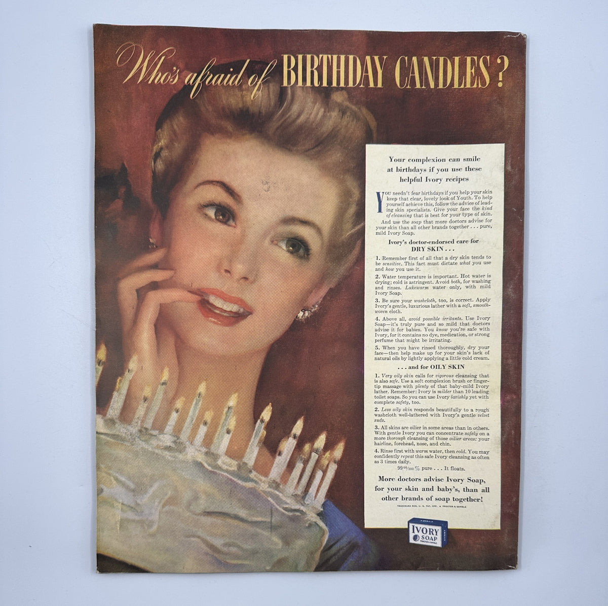 Cover of Woman’s Home Companion Magazine February 1943 titled 'Who’s Afraid of Birthday Candles?' featuring a model smiling attractively while holding a cake with lit candles, showcasing mid-20th century beauty and advertising style.