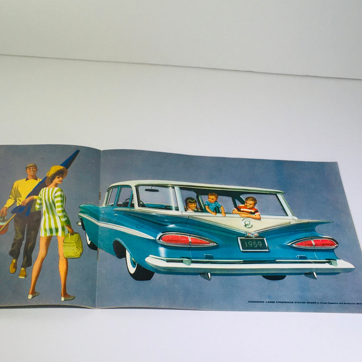 Interior illustration from the Vintage 1959 Chevrolet Kingswood 4-Door Station Wagon Hardtop Car Catalog Brochure, depicting a family enjoying a road trip with children in the back seat.