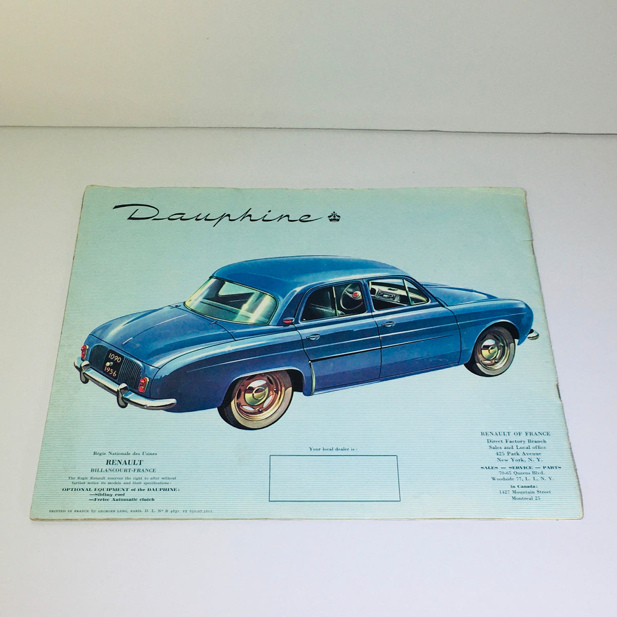 Vintage 1956 Renault Dauphine 4-Speed MT car brochure illustrating a blue Renault Dauphine with a focus on its classic design, emphasizing 1950s automotive elegance.