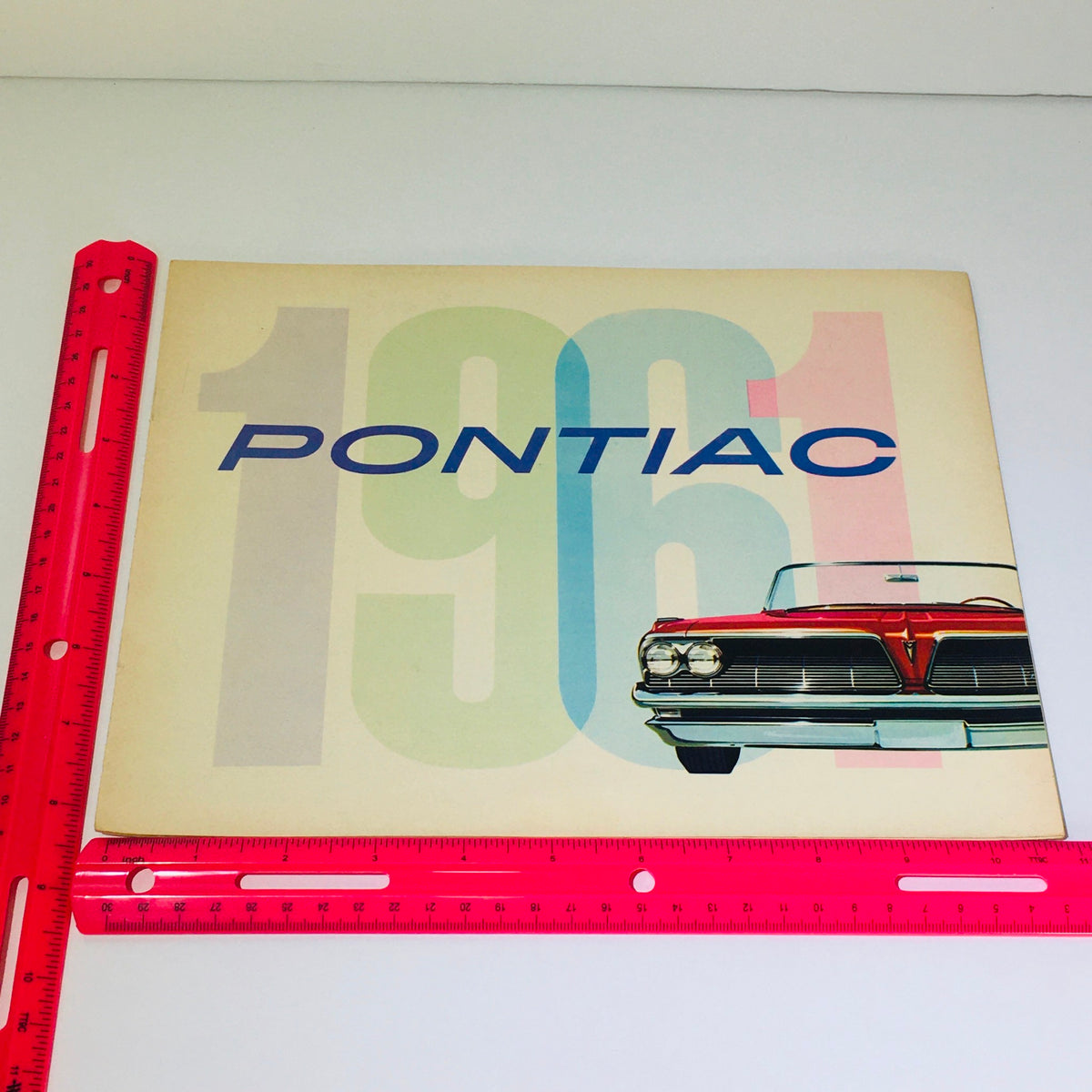 Cover page of the 1961 Pontiac brochure featuring bold graphics and the iconic Pontiac logo, celebrating the vintage Catalina Sports Coupe.