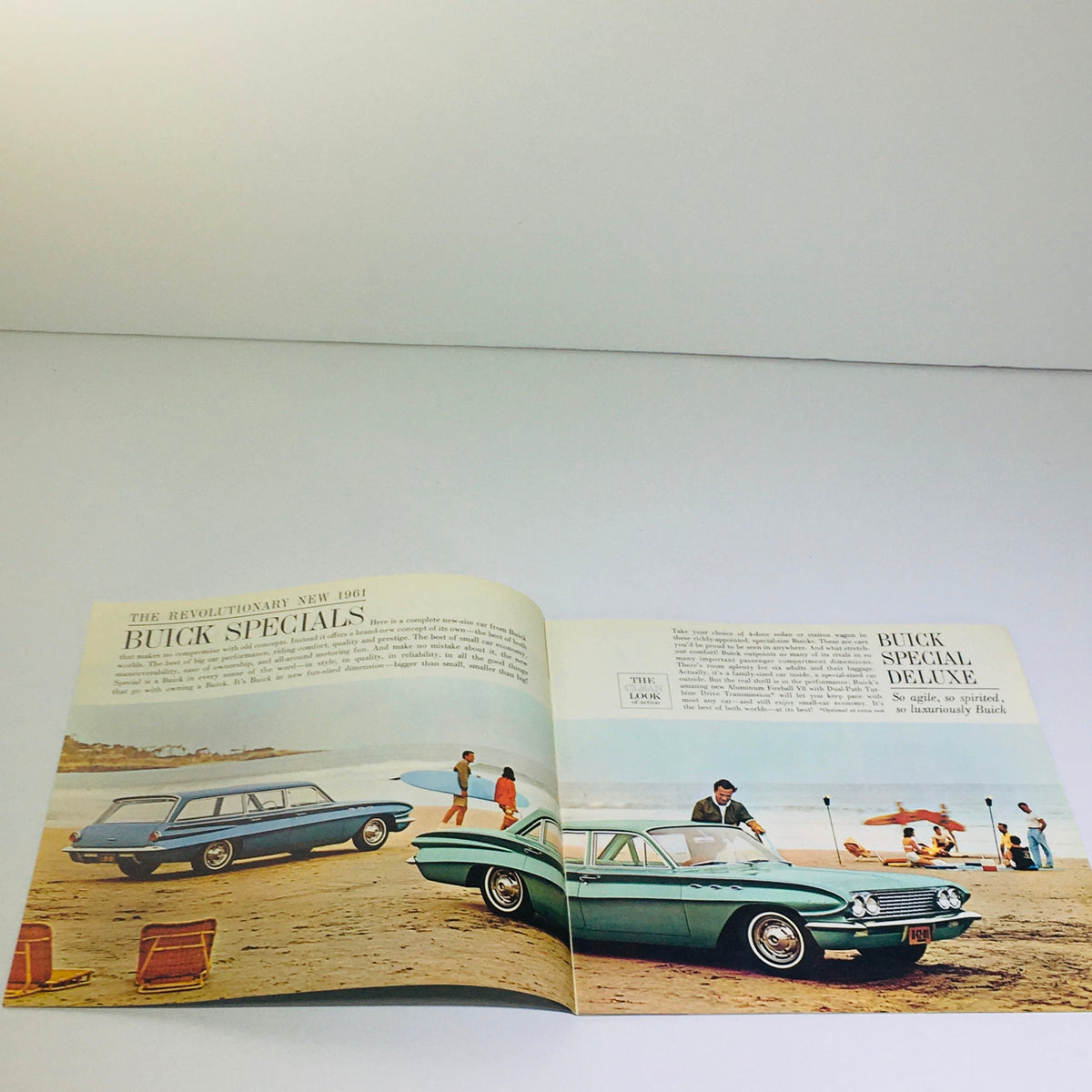 Vintage 1961 Buick Special Deluxe Sedan Station Wagon catalog brochure showcasing stunning automotive photography at a beach setting.