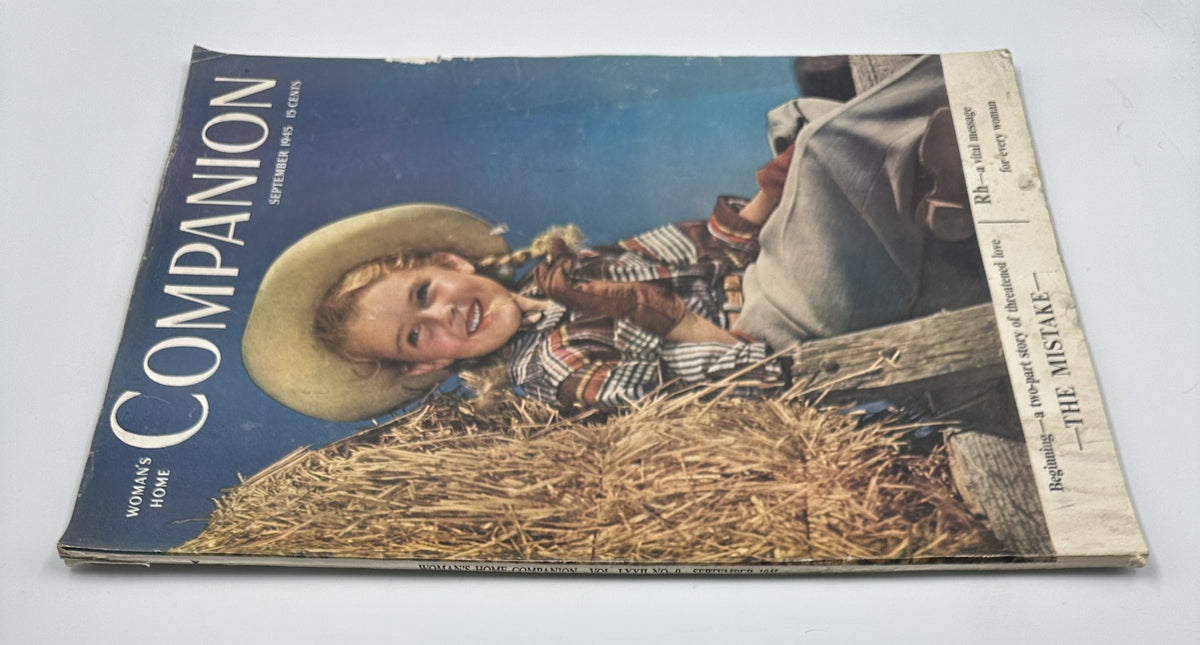 Front cover of Woman’s Home Companion Magazine September 1945 displaying the title 'The Mistake' along with a cheerful girl in a straw hat, with hay bales in the background, emphasizing a vital message for every woman.