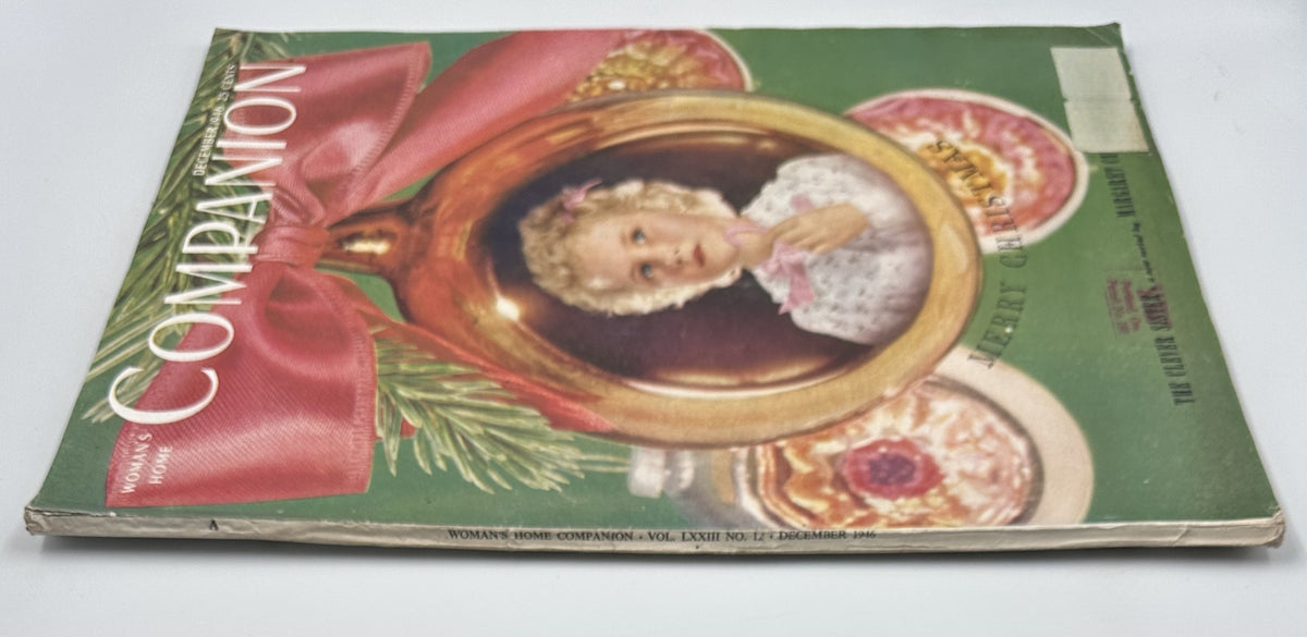 Side view of Woman’s Home Companion Magazine December 1946 showcasing the cover design featuring a young girl and festive decorations, along with the title 'Merry Christmas'.