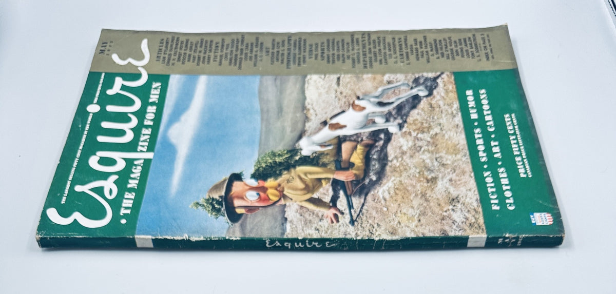 Another angle of the May 1942 cover of Esquire Magazine displaying a whimsical character with a dog, emphasizing the magazine's focus on various topics including fiction, humor, and styles for men.