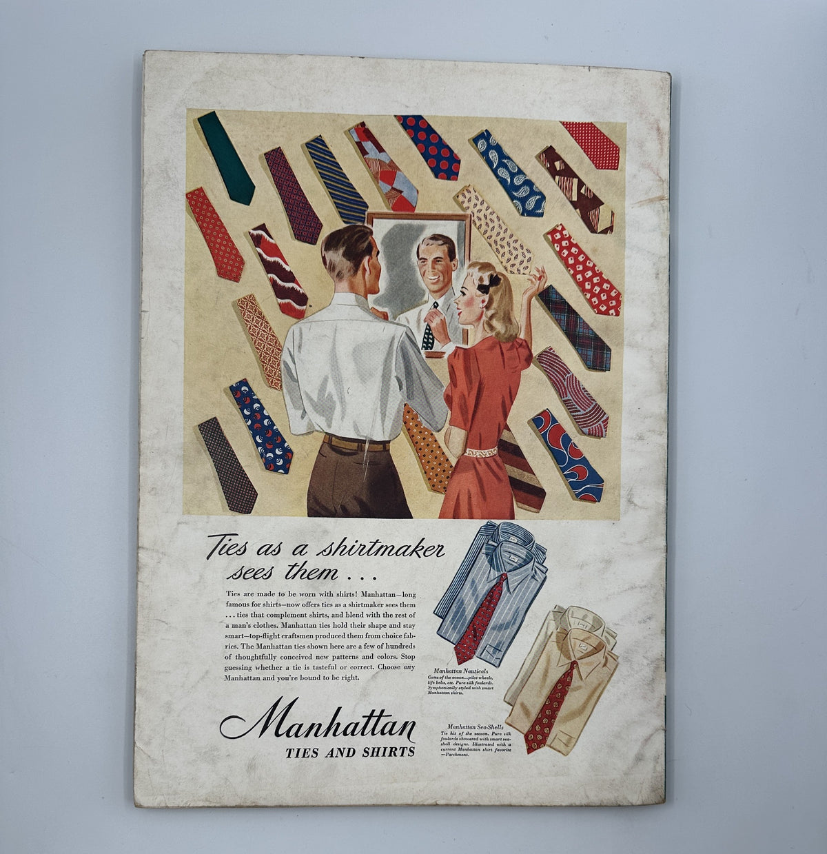 Back cover of Esquire Magazine May 1942, displaying a vintage advertisement for Manhattan Ties and Shirts, illustrating various tie designs and a fashionable couple.