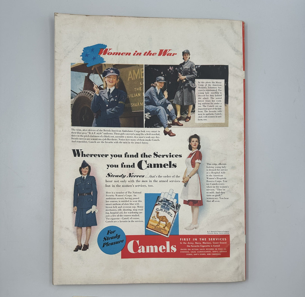 Advertisement from Esquire Magazine October 1942 titled 'Esquire Magazine October 1942 Varga Marjorie Woodworth Leydenfrost w Pinup'. The image promotes Camel cigarettes with visuals of women in military attire and a service theme, emphasizing the brand's presence in the armed services.