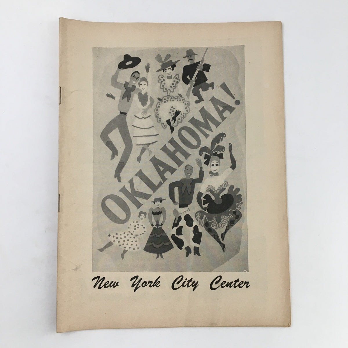 1953 Playbill for 'Oklahoma!' presented by Rodgers & Hammerstein at New York City Center, featuring an artistic cover illustration with characters from the musical.