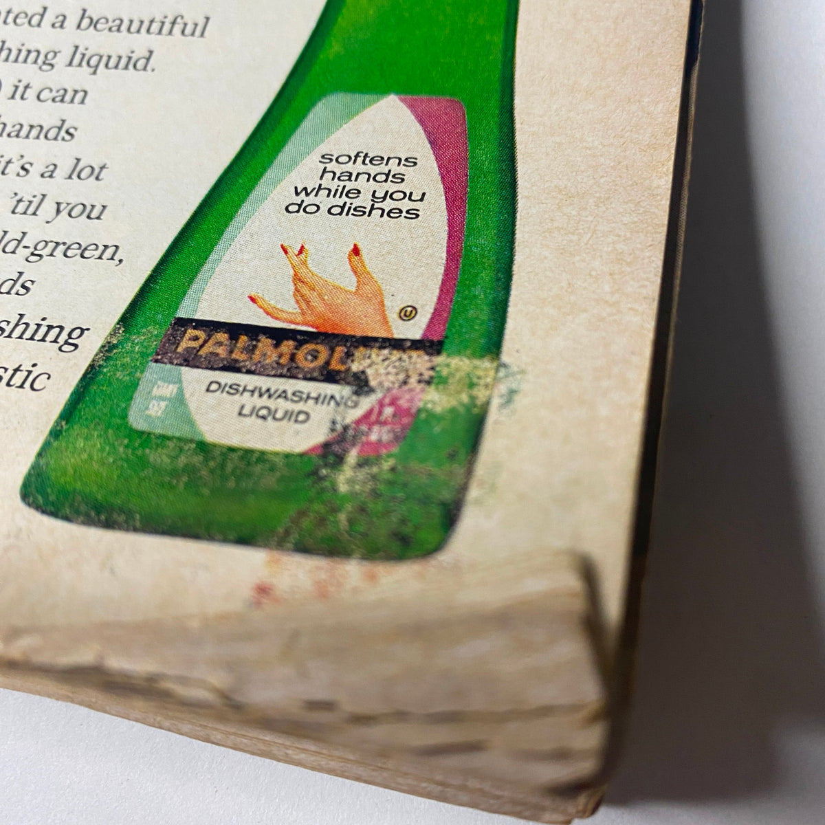 Close-up of a vintage advertisement for Palmolive Dishwashing Liquid, featured in Ebony Magazine December 1967. The label highlights its hand-softening properties while washing dishes.