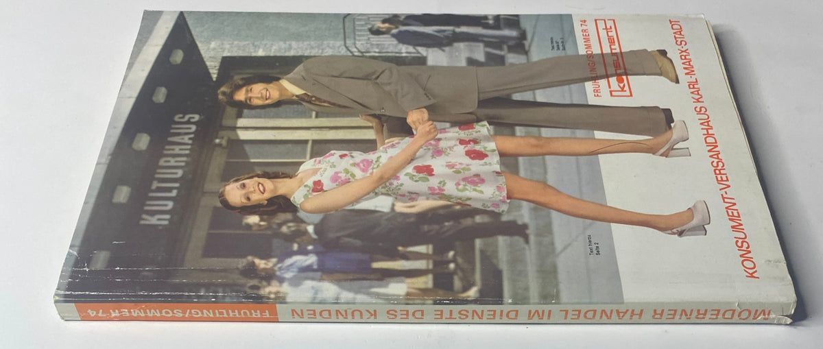 Side view of the 1974 Konsument Summer Catalog, prominently displaying summer fashion styles with a couple in front of Kulturhaus, highlighting East German design.