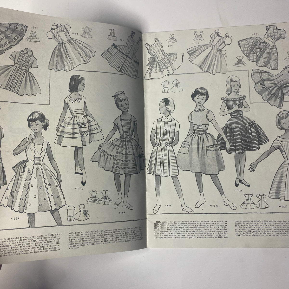 Interior page of the 1959 No. 55 Les Enfants Elegances Pratiques Catalog featuring illustrations of various styles of children's dresses and outfits, emphasizing vintage fashion designs.