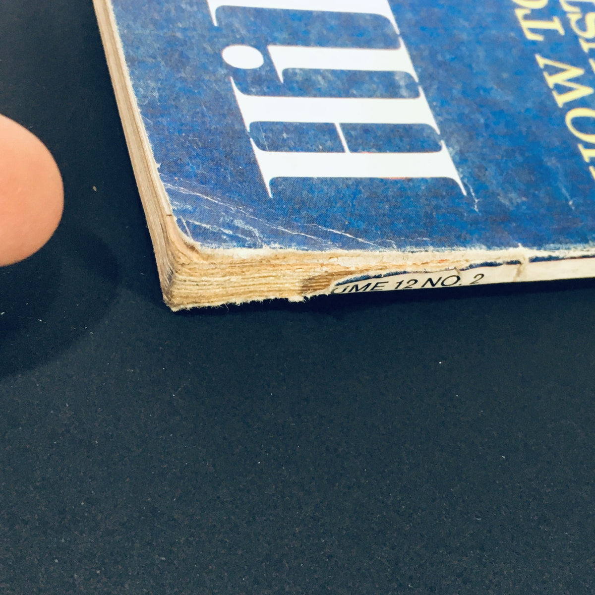 Close-up of the spine of the VTG HiFi Stereo Review Magazine February 1964, showing the magazine's title and issue number with signs of wear, highlighting its vintage condition.