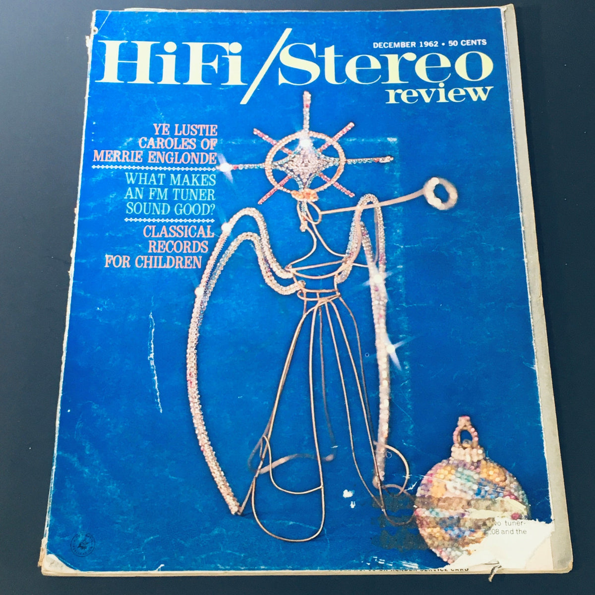 Cover of the VTG HiFi Stereo Review Magazine from December 1962 featuring a unique design titled 'Ye Lustre Caroles Merrie Englonde'. The magazine includes titles like 'What Makes an FM Tuner Sound Good?' and 'Classical Records for Children', showcasing articles on vintage audio technology.