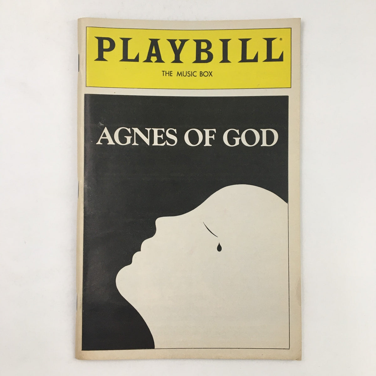 1983 Playbill for Agnes of God featuring a minimalist design with a silhouette of a face and a tear, presented at The Music Box Theatre.
