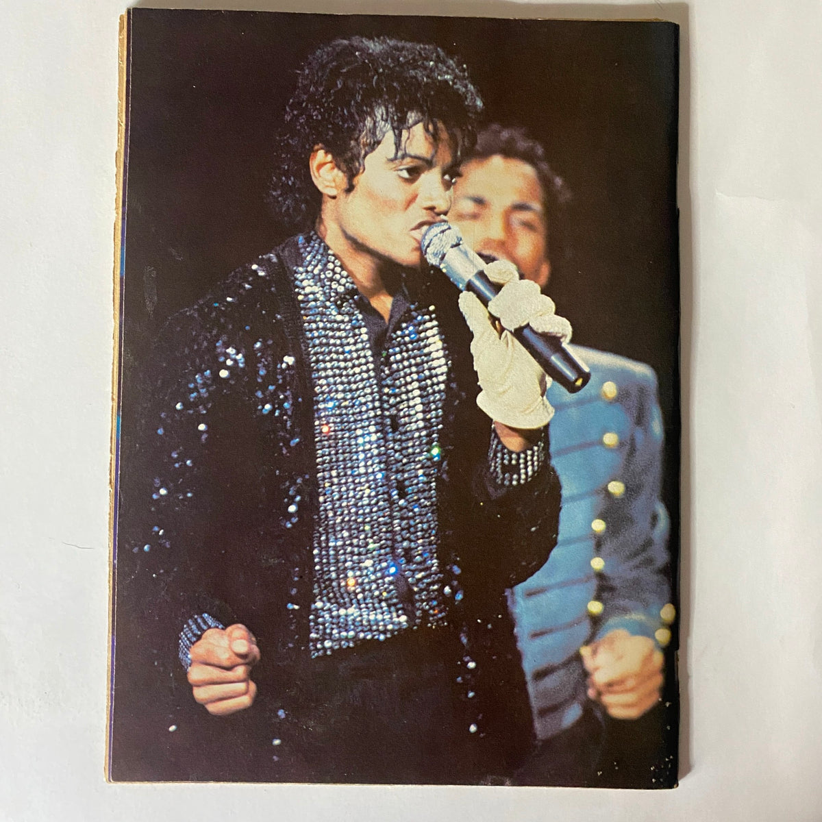 Iconic image of Michael Jackson performing live, as featured in VTG Right On Magazine February 1983, showcasing his sparkling outfit and captivating stage presence.