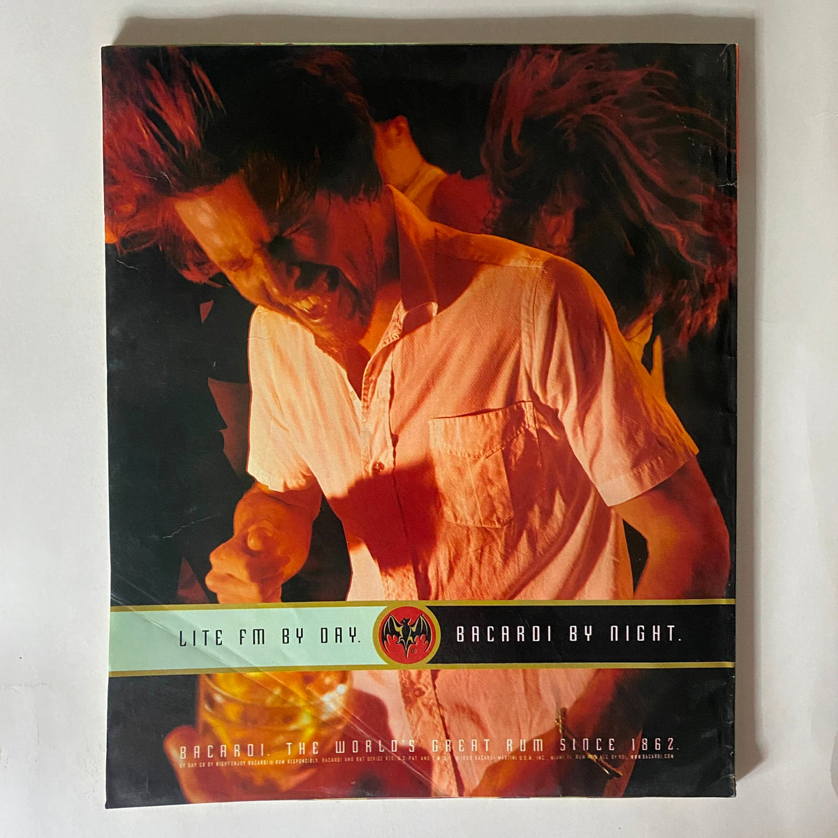 Back cover of Spin Magazine January 1999, featuring a vibrant advertisement showcasing nightlife, portraying a lively party atmosphere aligned with the magazine's focus on music and culture.