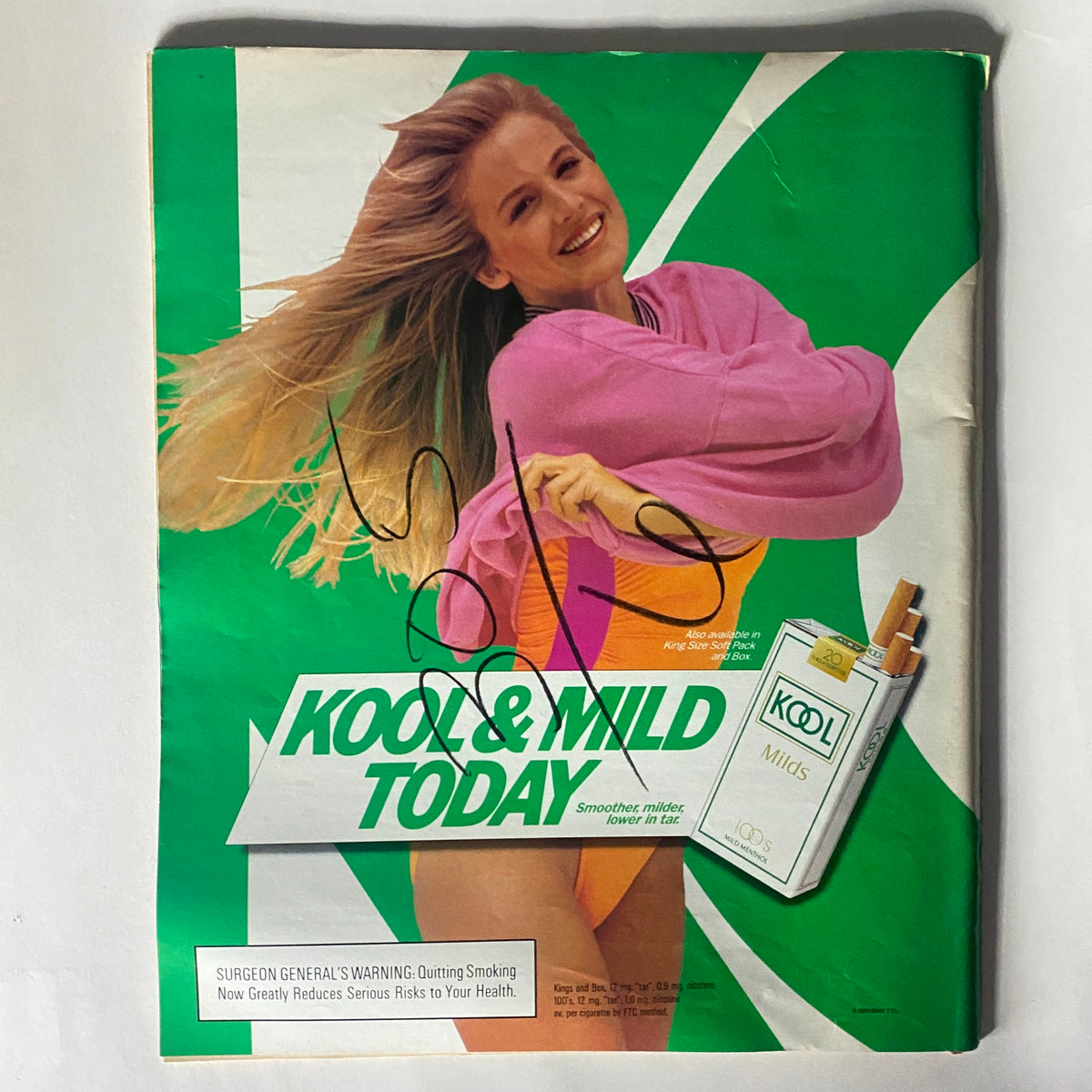 Kool & Mild advertisement featuring a smiling woman in a pink sweater, promoting smoking cessation, from Spin Magazine March 1990.