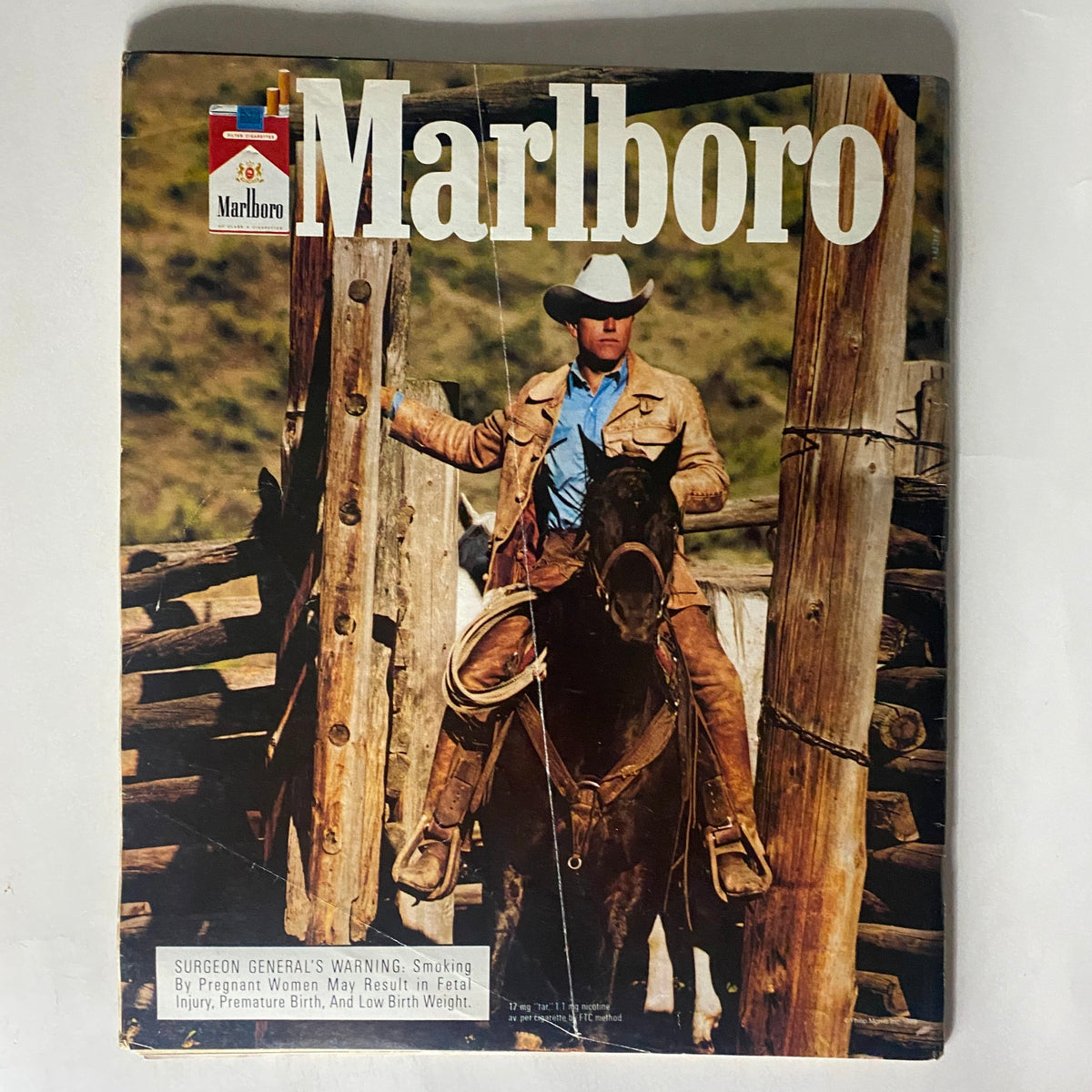 Cover of the Marlboro magazine featuring a cowboy on horseback, capturing a classic Western aesthetic.