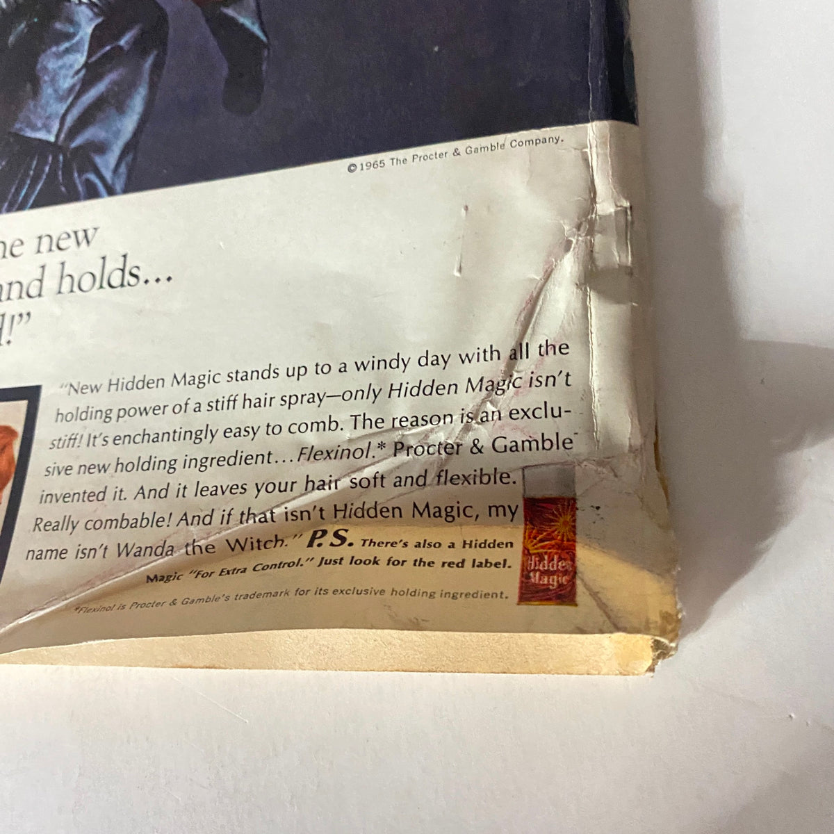 Close-up of the back cover of the September 1965 Redbook Magazine featuring the Hidden Magic hair spray advertisement, highlighting the text about the product's unique features and benefits.