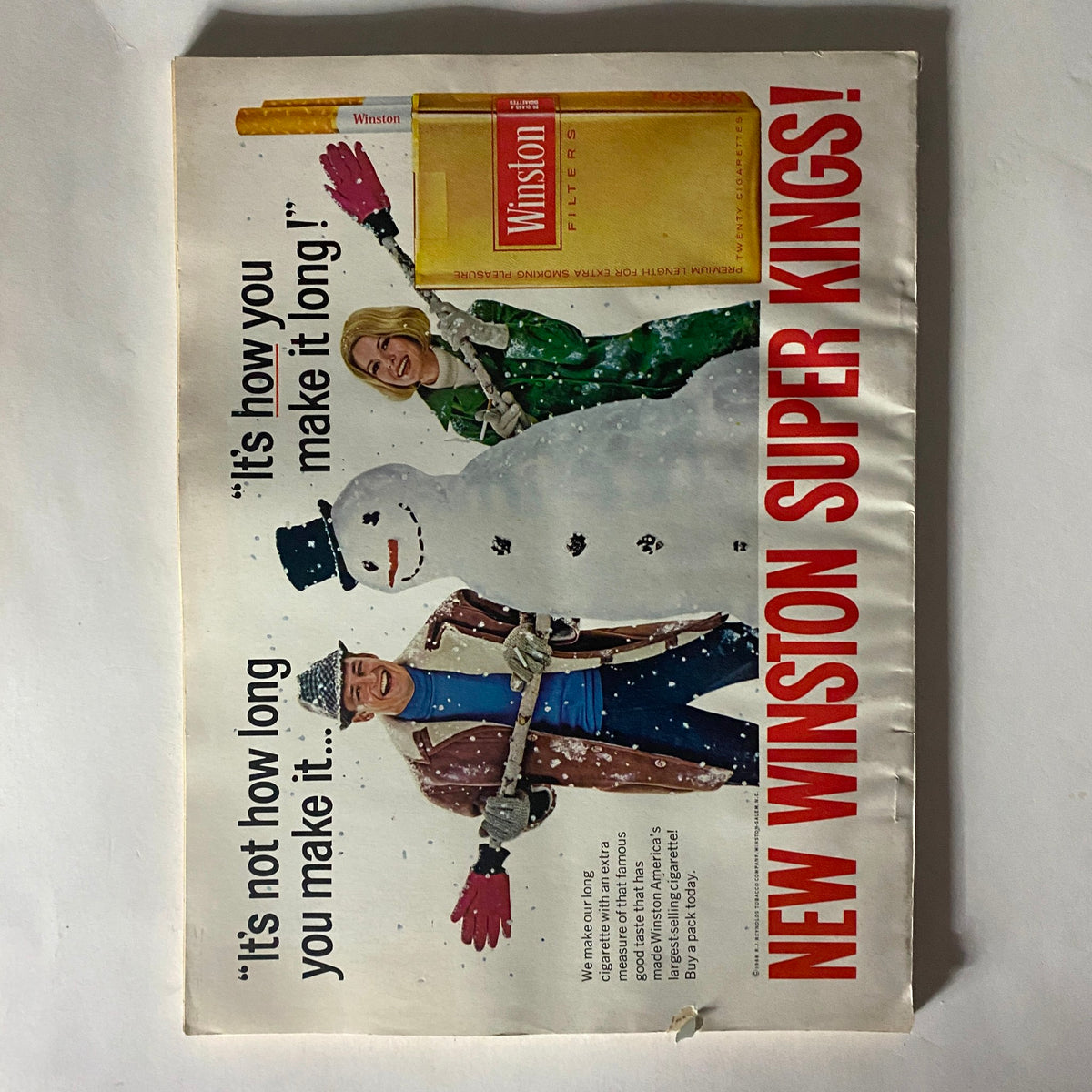Outdoor advertisement for Winston Super Kings cigarettes from the VTG Redbook Magazine February 1968, Volume 130, No. 4, featuring a playful winter scene.