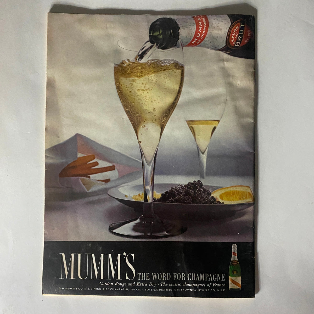 Advertisement page from VTG The Reporter Magazine June 16 1966, illustrating Mumm's champagne with an elegant visual of beverages and gourmet food, highlighting the luxury of the era.