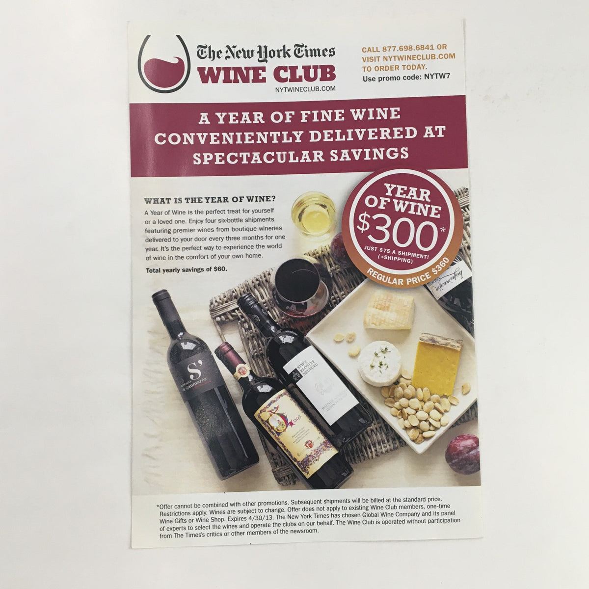 Promotional flyer for The New York Times Wine Club offering a year of fine wine at special savings, showcasing various wines and snacks.