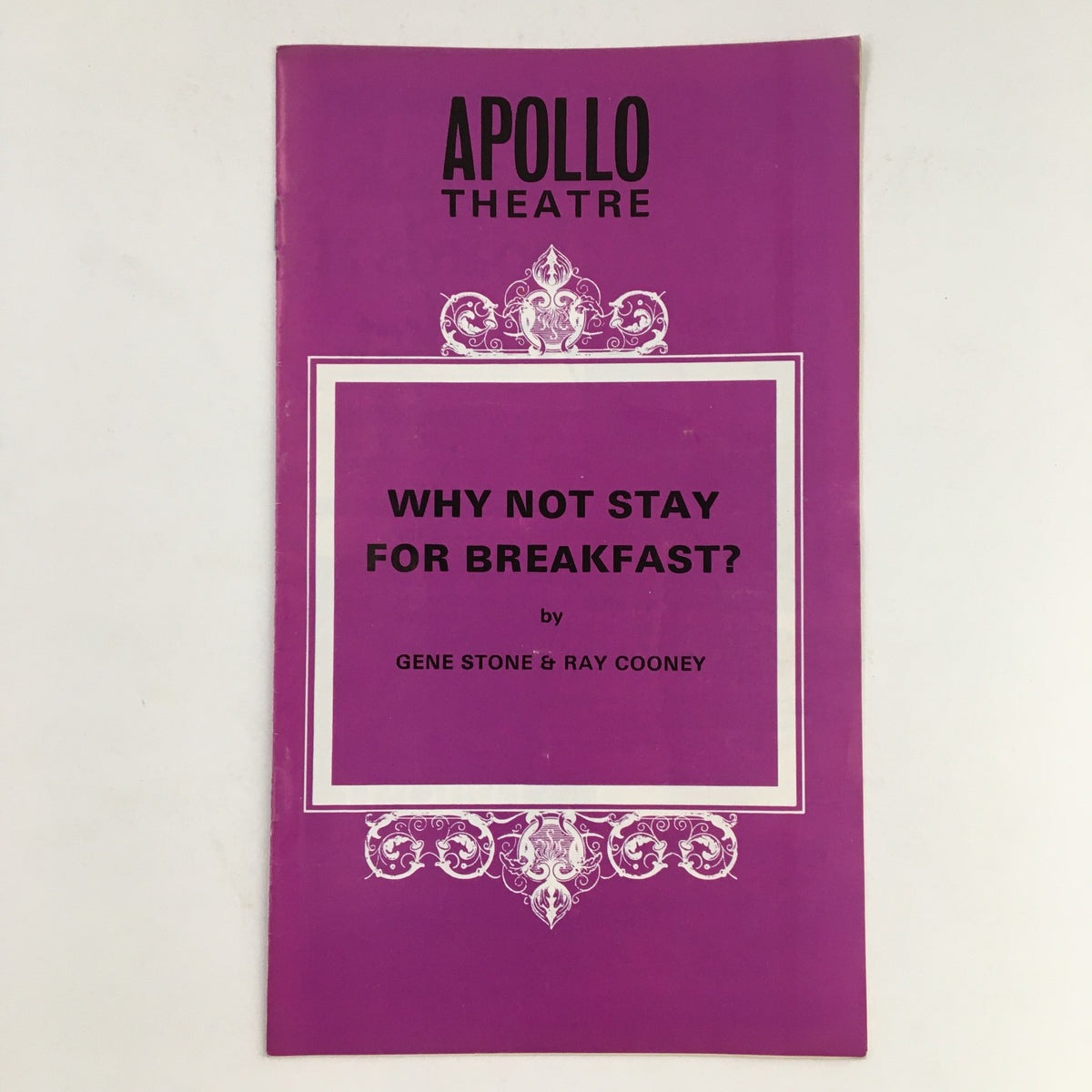 Cover of the 1973 Apollo Theatre program for 'Why Not Stay For Breakfast?' by Gene Stone and Ray Cooney, featuring bold text and a decorative border.