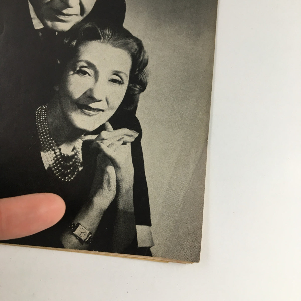 Close-up of the 1958 Playbill for The Visit, highlighting Alfred Lunt and Lynn Fontanne's expressions in a vintage black and white style.